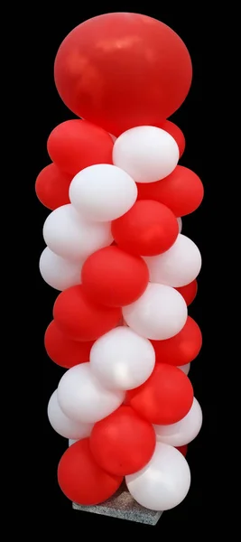 High vertical installation of red and white balloons on a granit — Stock Photo, Image