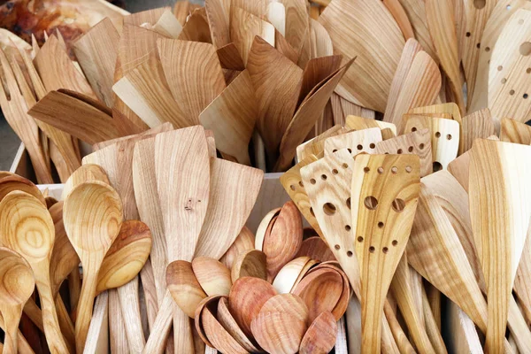 Wooden traditional kitchen spoons, forks and spatulas are sold a — Stock Photo, Image