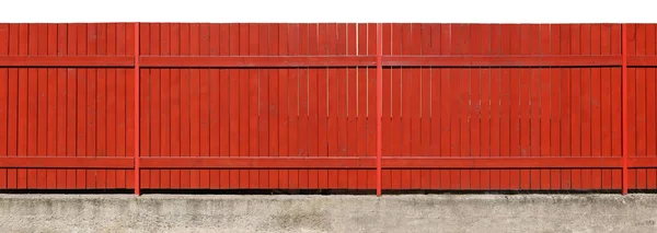 Long deep orange painted  solid wooden fence on the concrete bas — Stock Photo, Image