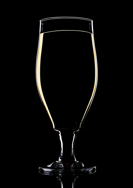 Glass of beer cider with yellow lines on black — Stock Photo, Image