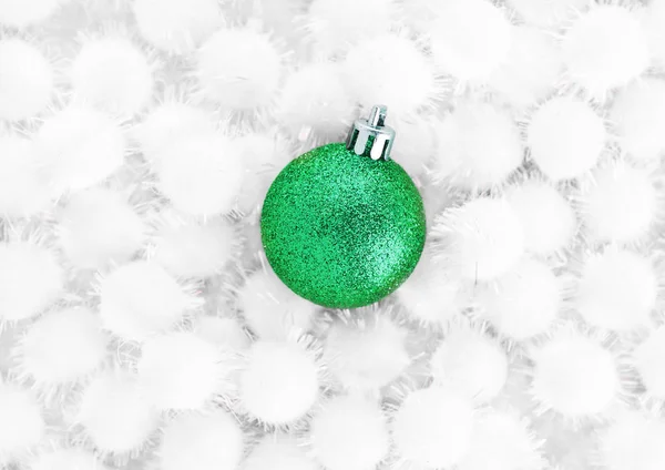 Green christmas ball on snow balls on white — Stock Photo, Image