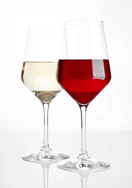 Glasses of red and white wine on white — Stock Photo, Image