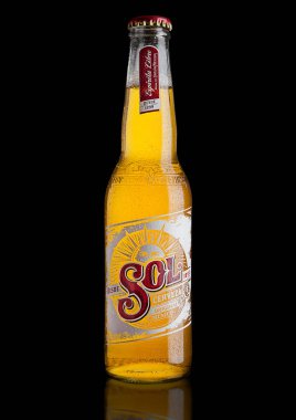 LONDON, UK - DECEMBER 15, 2016: Bottle of Sol Mexican Beer on black background. From the Cuauhtemoc Moctezuma Brewery, in Monterey, Mexico, it was first introduced in the 1890's as El Sol. clipart