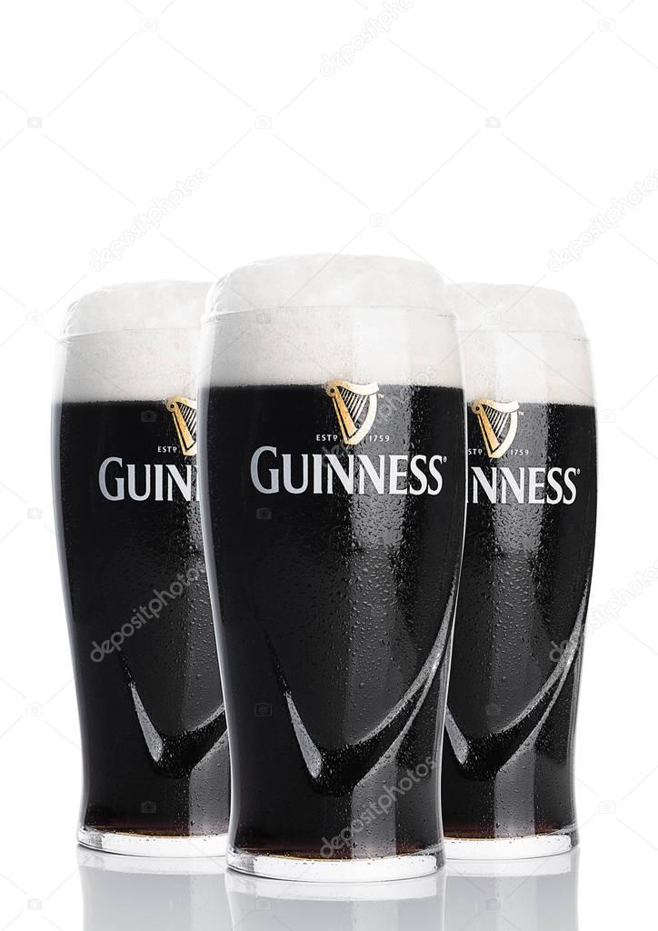 LONDON, UK - FEBRUARY 26, 2017: Glasses of Guinness original beer on white background. Guinness beer has been produced since 1759 in Dublin, Ireland.