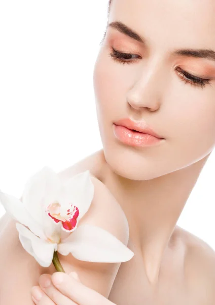 Beauty fashion model holding white orchid at spa — Stock Photo, Image