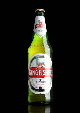 LONDON,UK - MARCH 23, 2017 : Bottle of Kingfisher beer on black. Kingfisher is the Number one beer of India. clipart