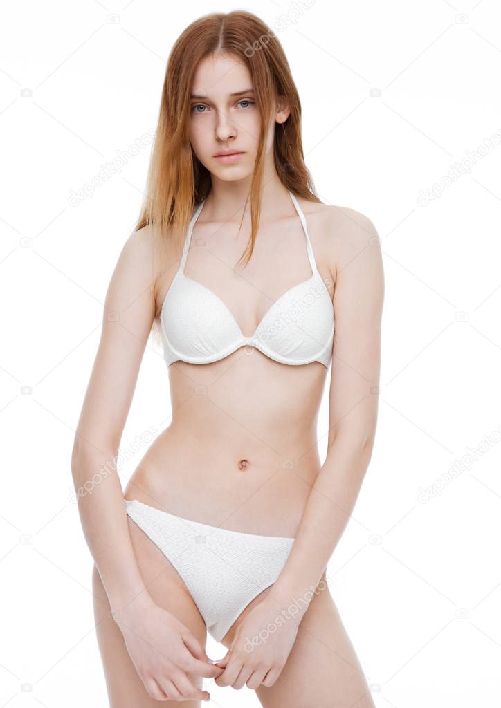 Young fit fashion model wearing white bikini