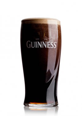 LONDON, UK - MAY 29, 2017: Cold glass of Guinness original beer on white. Guinness beer has been produced since 1759 in Dublin, Ireland. clipart