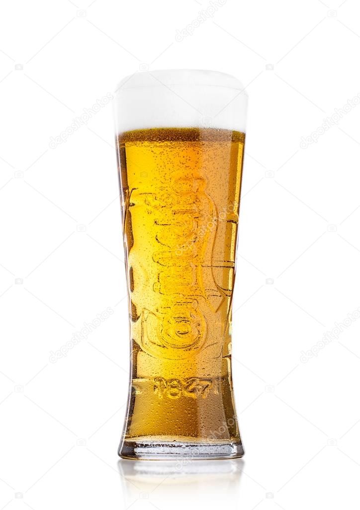 LONDON, UK - MAY 29, 2017: Cold glass Of Carlsberg beer on white background. Danish brewing company founded in 1847.
