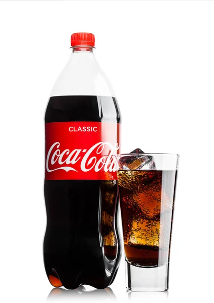 LONDON, UK - JUNE 9, 2017: Bottle and glass with ice cubes of Coca cola soft drink on white.The Coca-Cola Company, an American multinational beverage corporation. — Stock Photo, Image