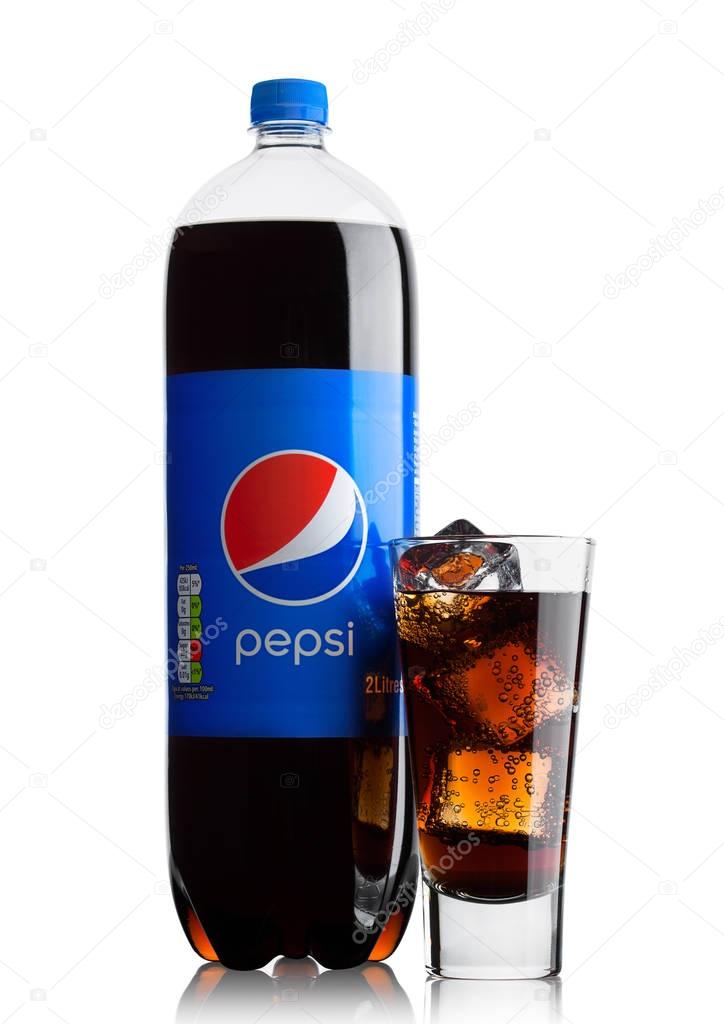 LONDON, UK - JUNE 9, 2017: Bottle and glass with ice cubes of Pepsi Cola soft drink on white background.American multinational food and beverage company
