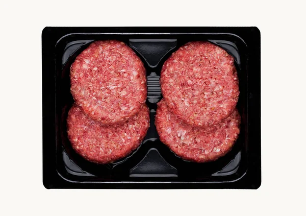 Raw fresh beef burgers in plastic tray — Stock Photo, Image