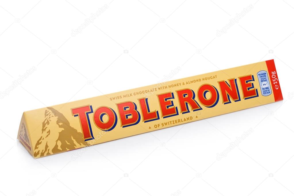 LONDON, UK -DECEMBER 07, 2017: Toblerone Swiss Milk Chocolate with Honey and Almond Nougat on white background. Toblerone is a Swiss chocolate.