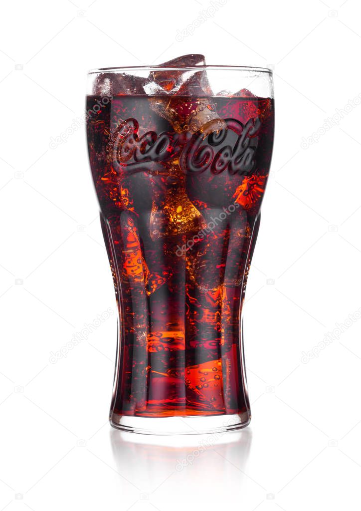 LONDON, UK - JANUARY 02, 2018: Original glass of Coca Cola drink on white background. The drink is produced and manufactured by The Coca-Cola Company.