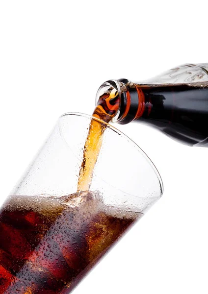 Pouring cola soda drink from bottle to glass — Stock Photo, Image