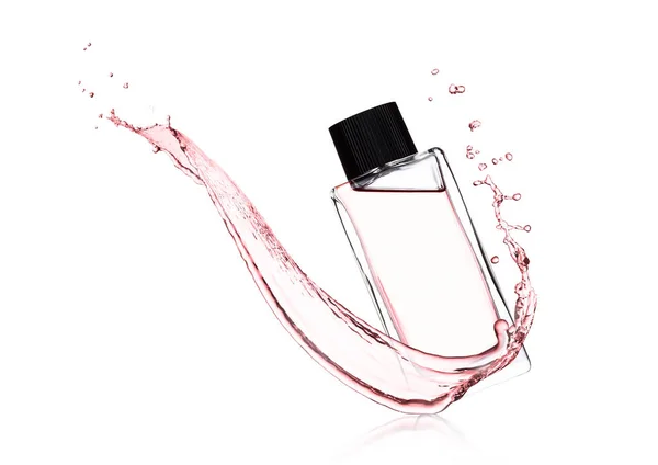 Frasco de perfume líquido rosa de luxo com salpicos — Fotografia de Stock