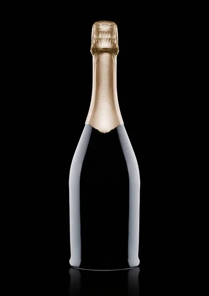 Bottle of champagne with yellow foil on black — Stock Photo, Image