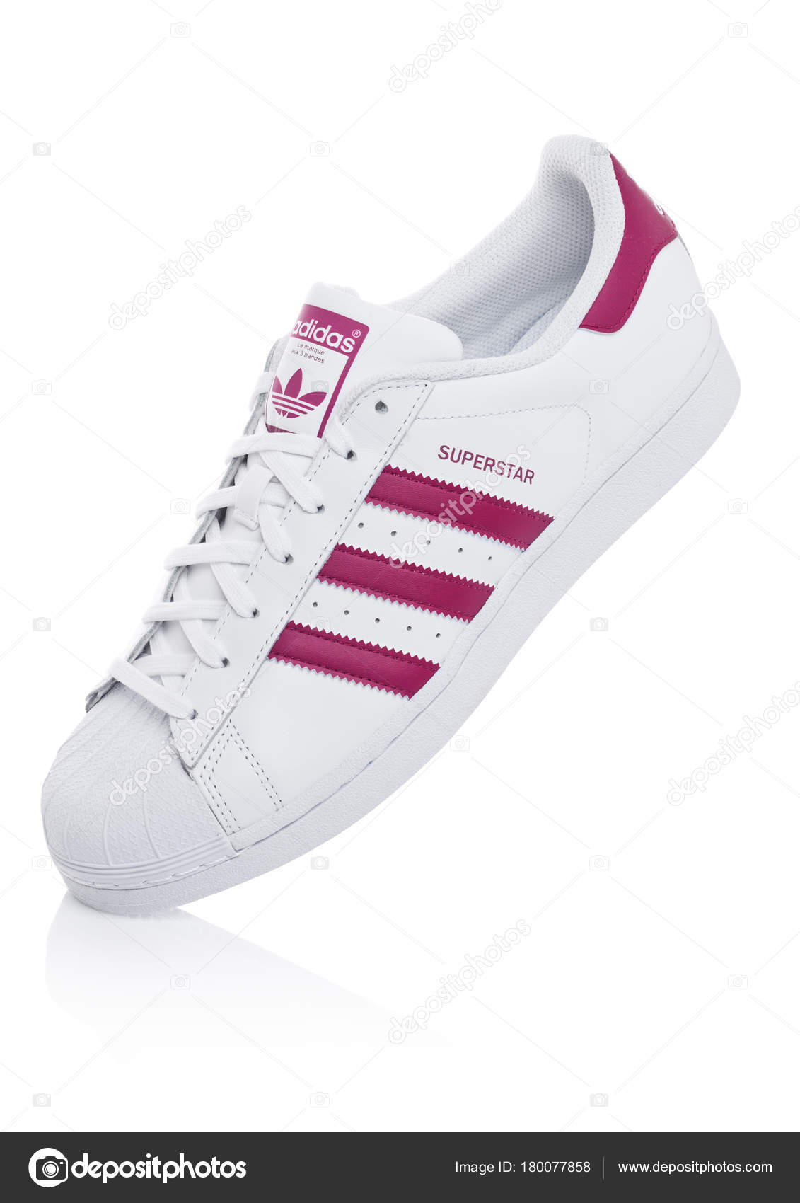LONDON, UK - JANUARY 12, 2018: Adidas Originals Superstar red shoes on white.German multinational corporation that designs and manufactures sports clothing and accessories. – Stock Editorial Photo © DenisMArt #180077858