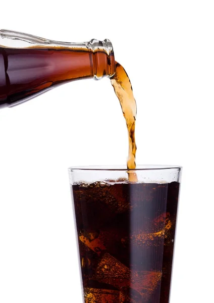 Pouring cola soda drink from bottle to glass — Stock Photo, Image