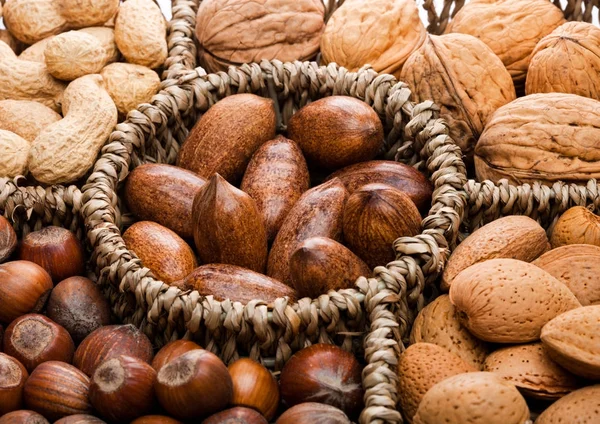 Basket reach in various kinds of nuts in shells — Stock Photo, Image