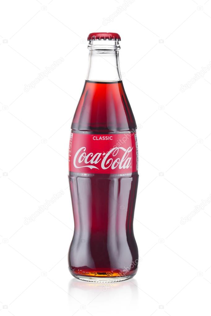 LONDON, UK - JANUARY 20, 2018: Cold glass bottle of Coca Cola drink on white background. The drink is produced and manufactured by The Coca-Cola Company.