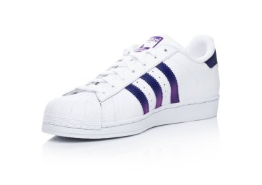 LONDON, UK - JANUARY 24, 2018: Adidas Originals Superstar blue shoes on white.German multinational corporation that designs and manufactures sports shoes, clothing and accessories. clipart
