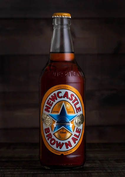 LONDON, UK - FEBRUARY 02, 2018: Bottle of Newcastle Brown craft ale beer on wood with dew and reflection. — Stock Photo, Image