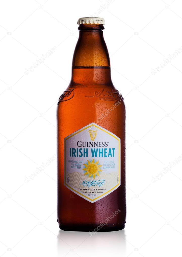 LONDON, UK - FEBRUARY 02, 2018: Cold bottle of Guinness Irish Wheat beer on white background.