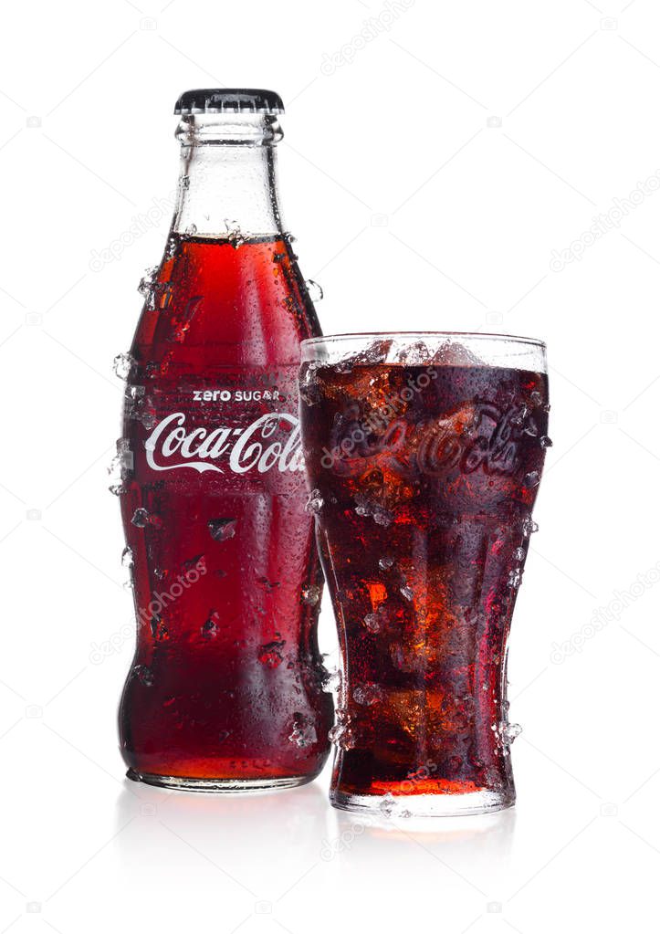 LONDON, UK - FEBRUARY 02, 2018: Cold bottle and glass of Zero Coca Cola drink with ice and dew on white background. The drink is produced and manufactured by The Coca-Cola Company.