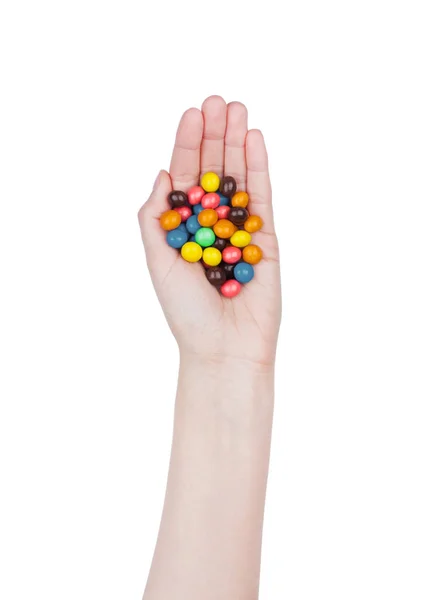 La mano femenina sostiene caramelos de chocolate de color redondo — Foto de Stock