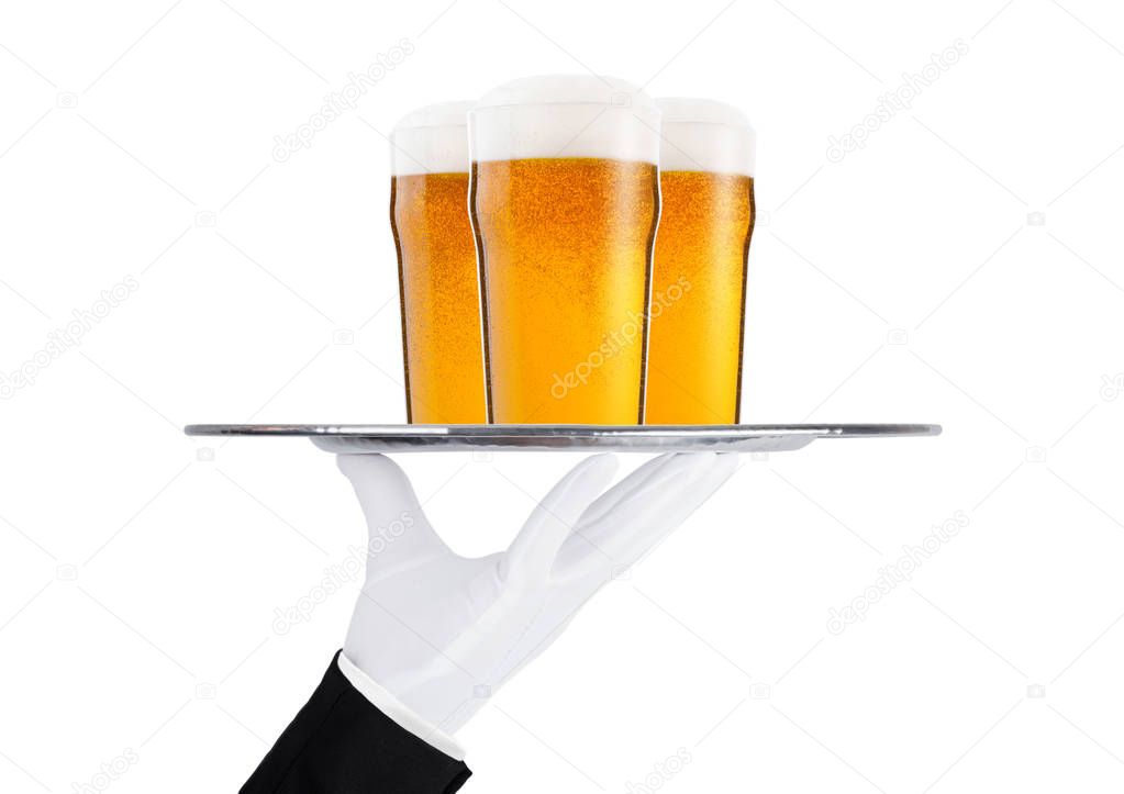 Hand with glove holds tray with lager beer glass
