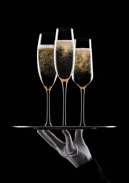 Hand with glove holds tray with champagne glasses — Stock Photo, Image