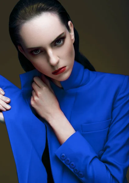 Fashion model with wet hair wearing blue long coat — Stock Photo, Image