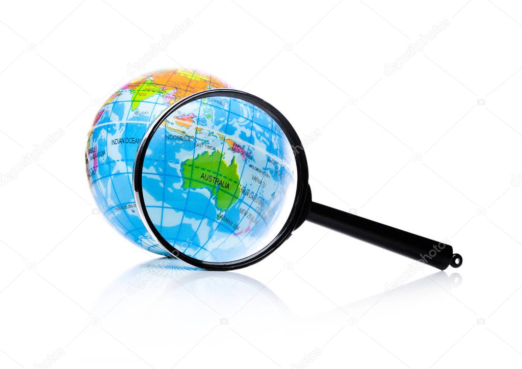 Globe under magnifying glass zooming Australia