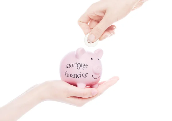 Mão feminina detém financiamento hipotecário porquinho — Fotografia de Stock