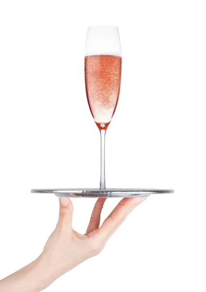 Hand houdt lade met roze champagne glas — Stockfoto
