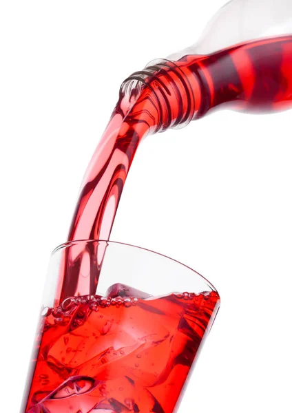 Pouring cranberry red juice from bottle to glass — Stock Photo, Image