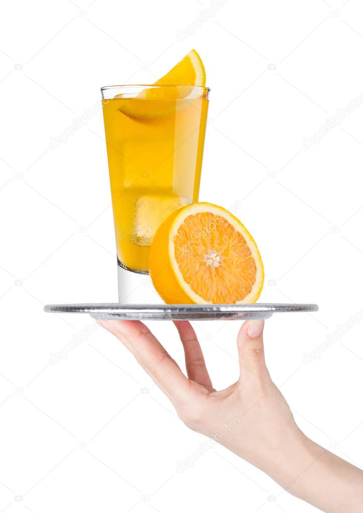 Hand  holds tray with glass of orange soda drink