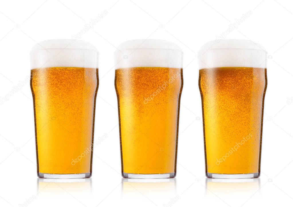 Cold glasses of lager beer with foam and dew