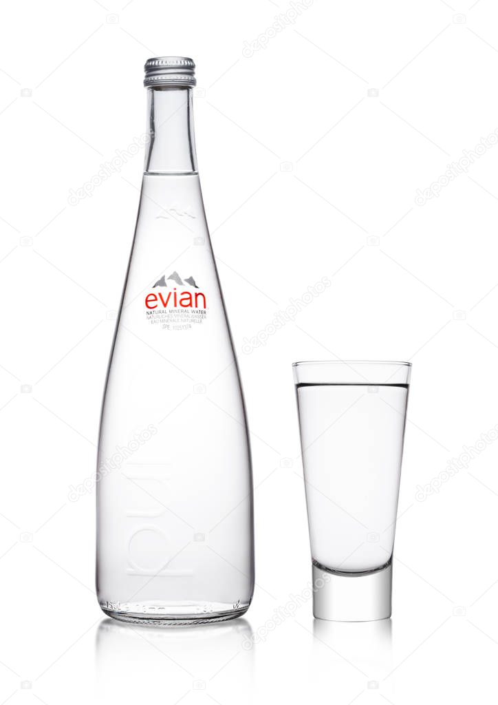 LONDON, UK - MARCH 01, 2018: Glass bottle of Pure Evian Natural Mineral Water on a white background. Made in France.