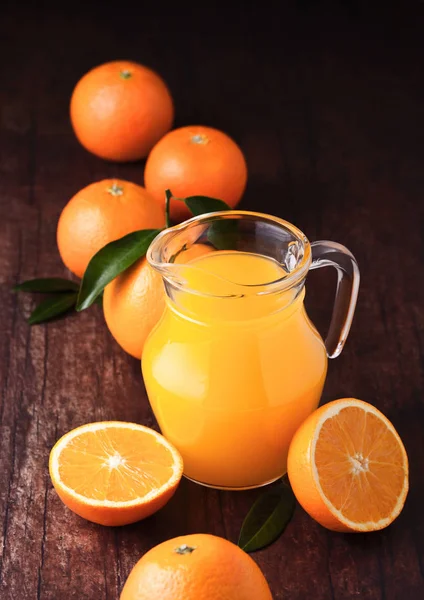 Glass jar of raw organic fresh orange juice on wood — Stock Photo, Image