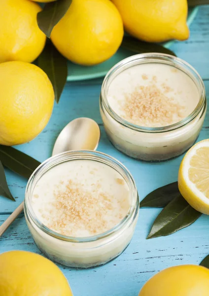Glass jar with lemon cheesecake with fresh lemons — Stock Photo, Image