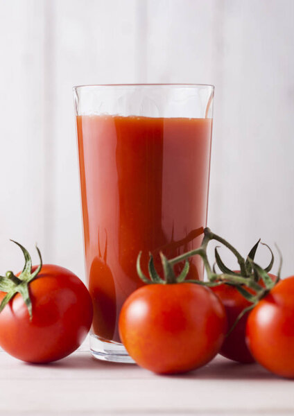 Glass of fresh organic tomato juice with tomatoes 