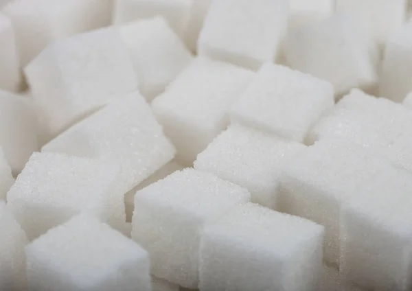 Close-Up shot of natural white sugar cubes on white background. — Stock Photo, Image