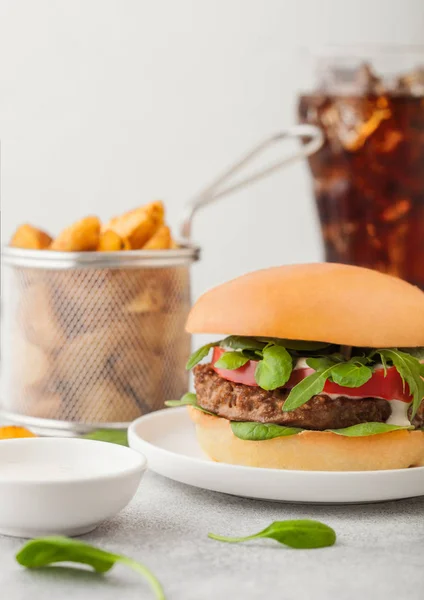 Healthy vegetarian meat free burger on round ceramic plate with vegetables on light table background with potato wedges and glass of cola. — Stock Photo, Image