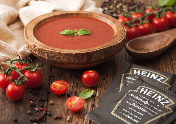 London, Storbritannien - november 08, 2019: Påsar av Heinz Krämig tomat kopp soppa med träplatta av krämig tomat soppa med träsked på trä bakgrund. — Stockfoto
