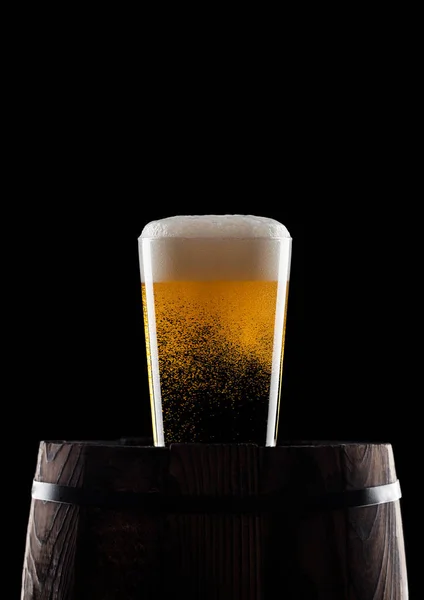 Cold glass of craft beer on old wooden barrel — Stock Photo, Image