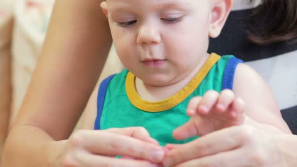 Beautiful baby boy sculpts the clay with his mother at home. Together having fun and making animal figurines. child education concept — Stock Video