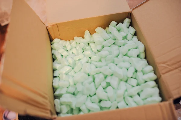 Box filled with many white styrofoam pellets — Stock Photo, Image