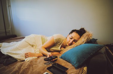 baş ağrısı ile yatakta yatan hasta bir kadın